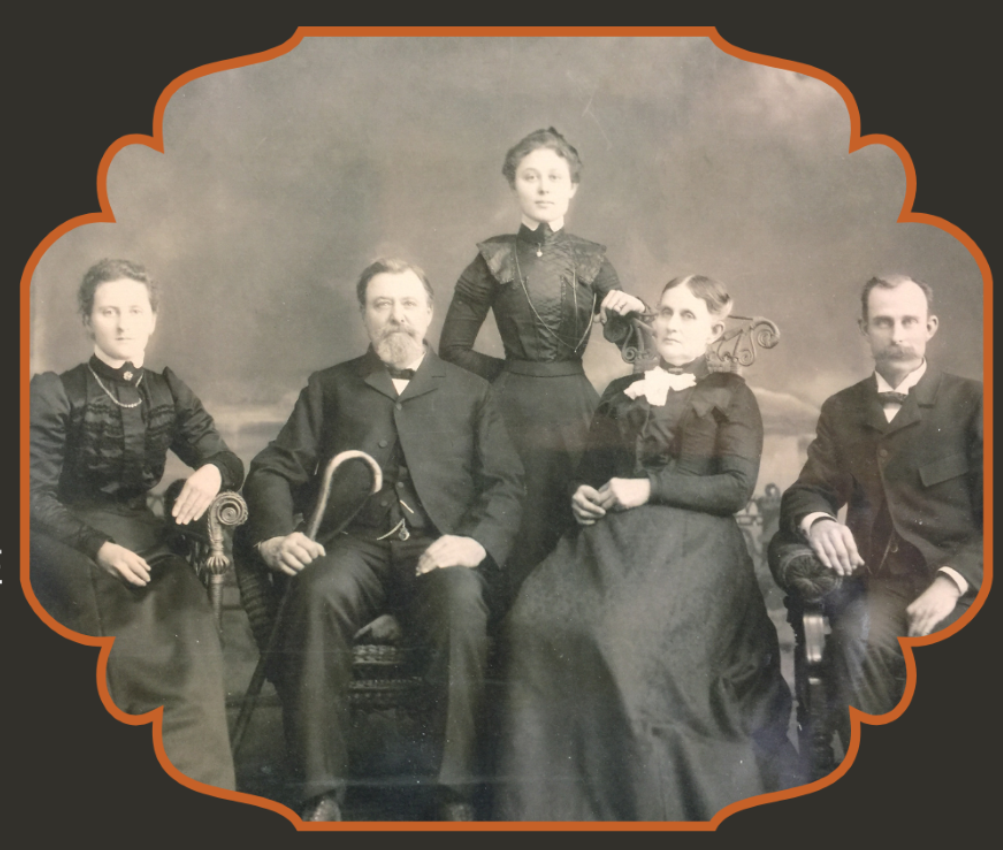 Black and white photo of family in Victorian clothing 
