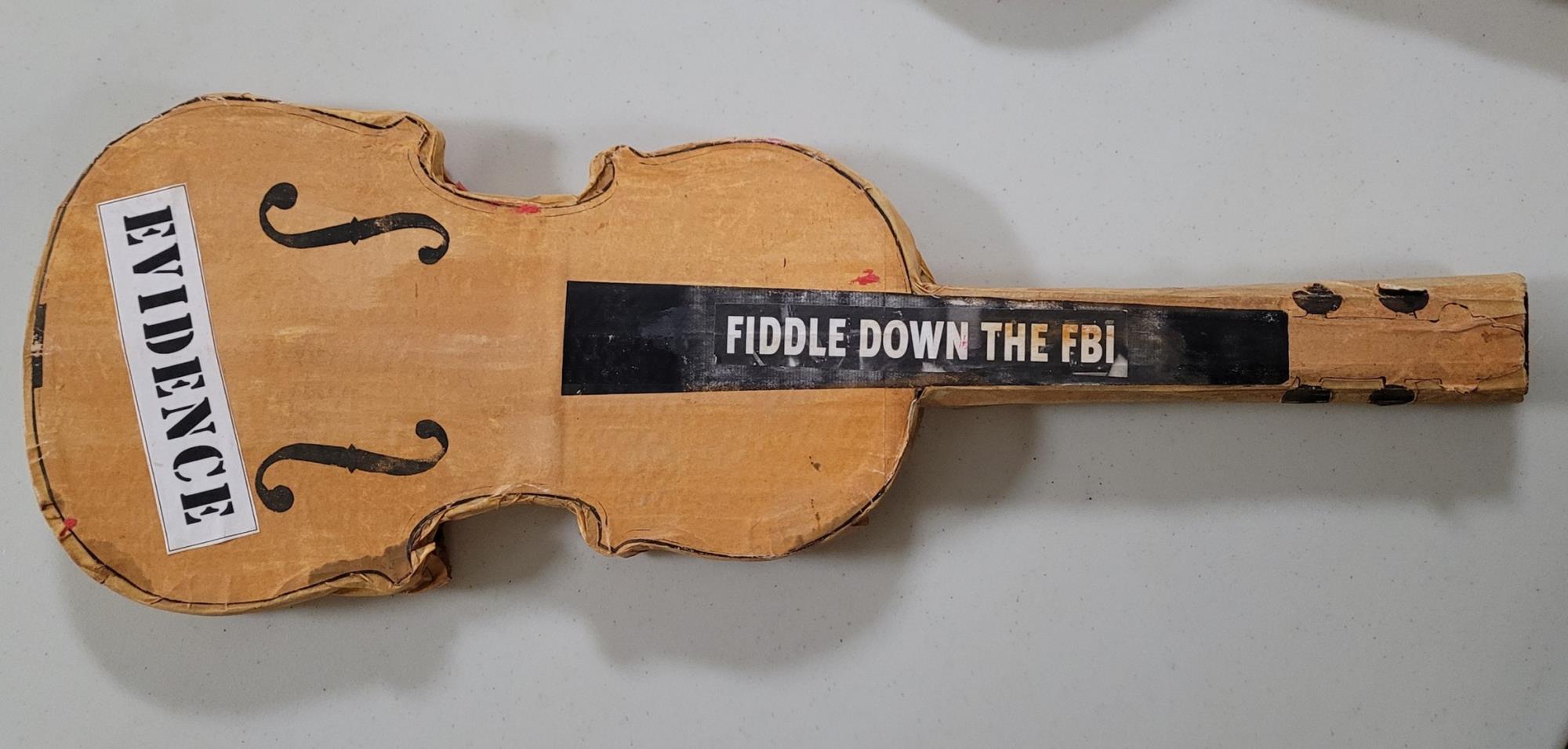 Fiddle with a stickers that read "Evidence" and "Fiddle Down the FBI"